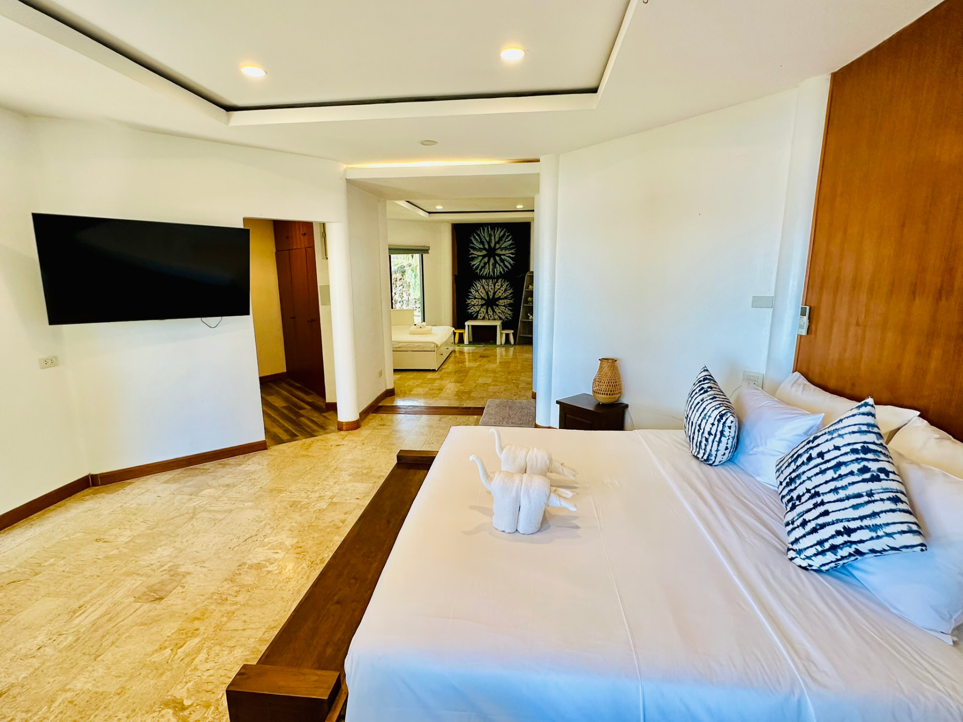 King bed with the doorway through to the second bedroom beyond