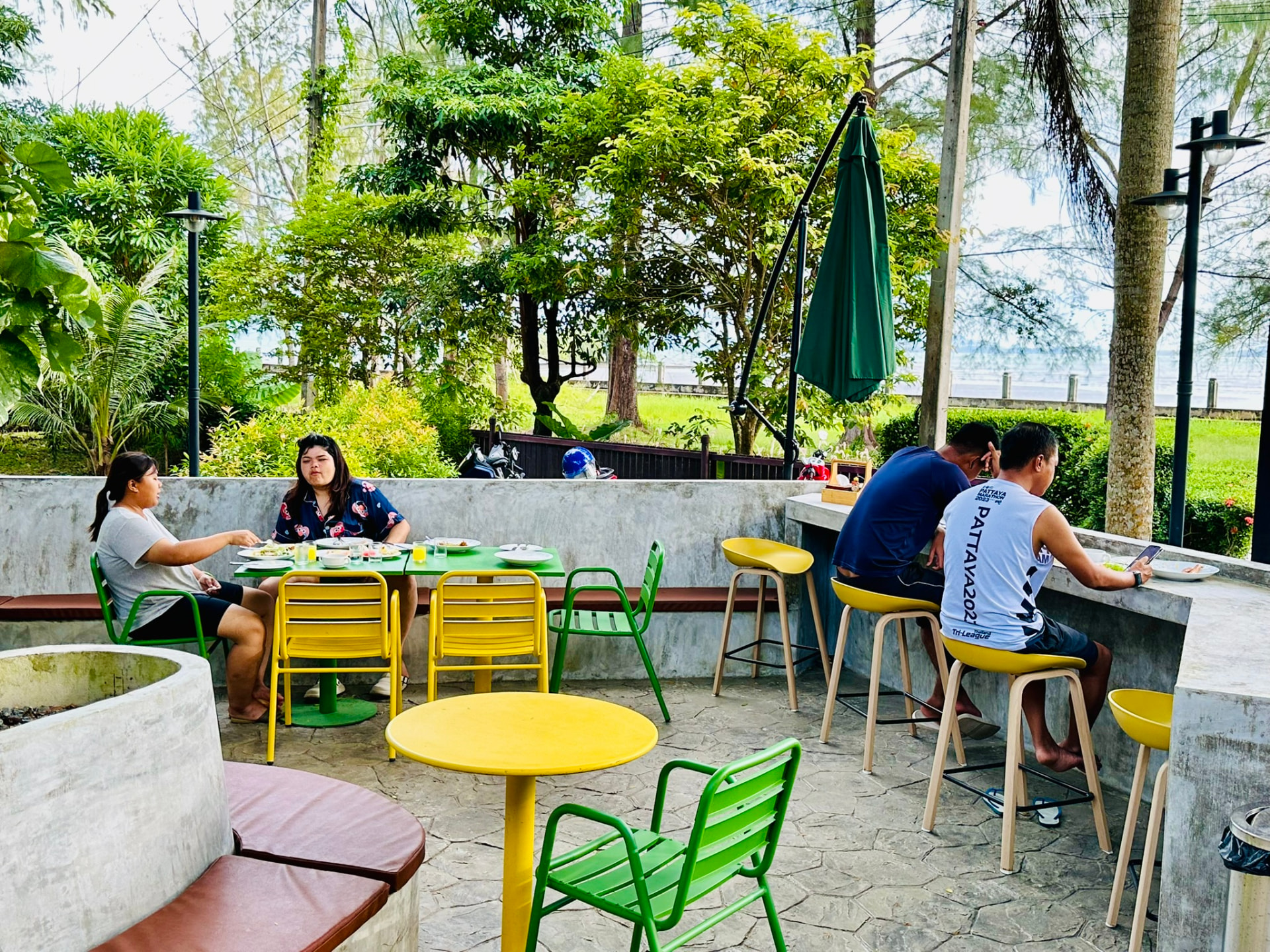 Guests eating lunch at the tables and bar counter of PineNapple Cafe