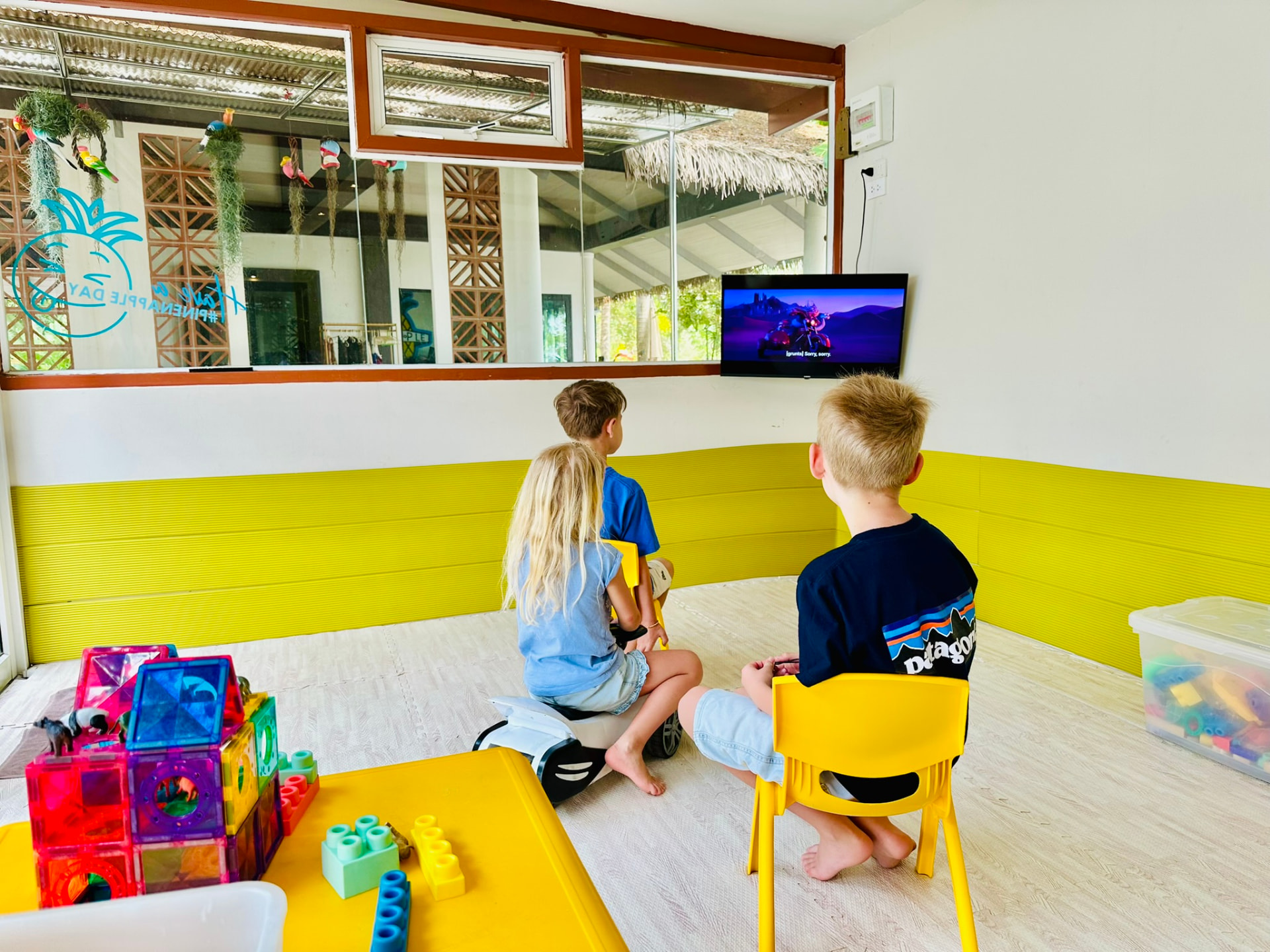 Three children watching a cartoon together in the Kids Room