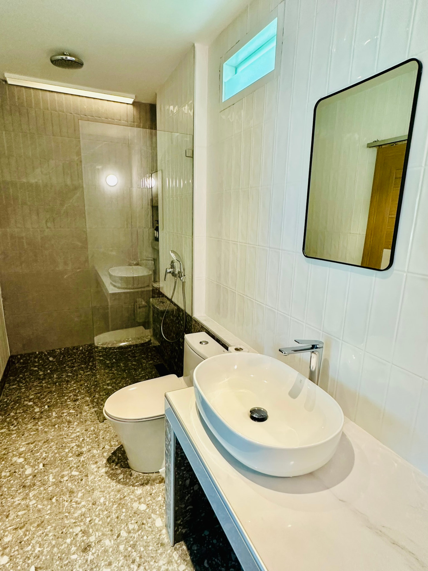 Bathroom with walk-in rain shower, terrazzo floor and vessel basin