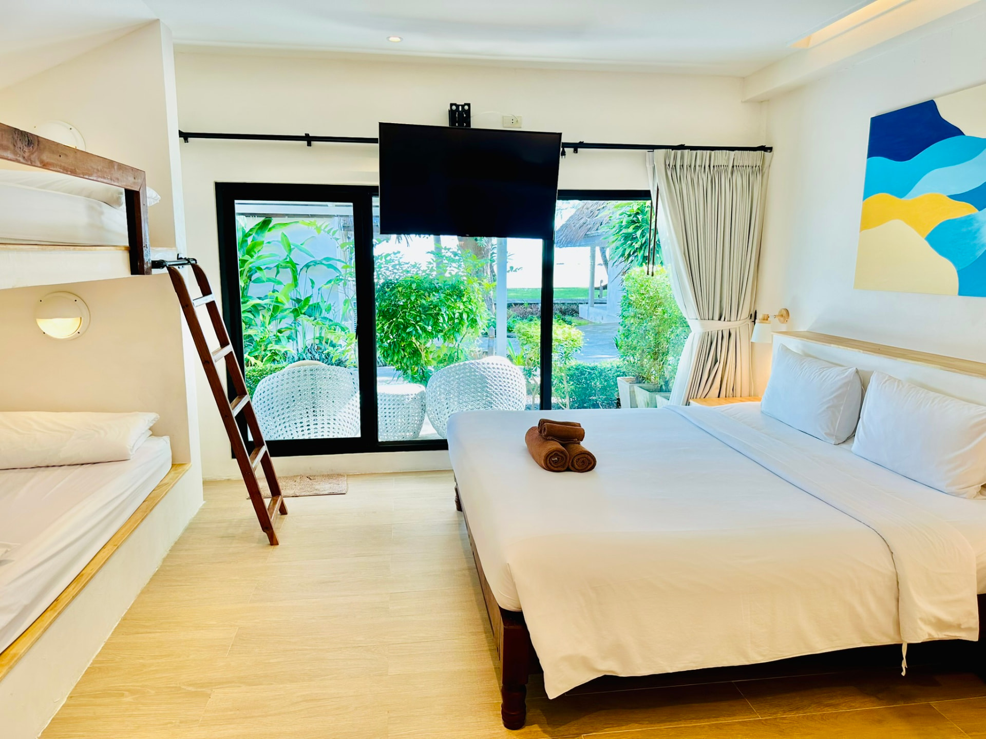 Built-in bunk beds beside the king bed in a Superior Family Bungalow
