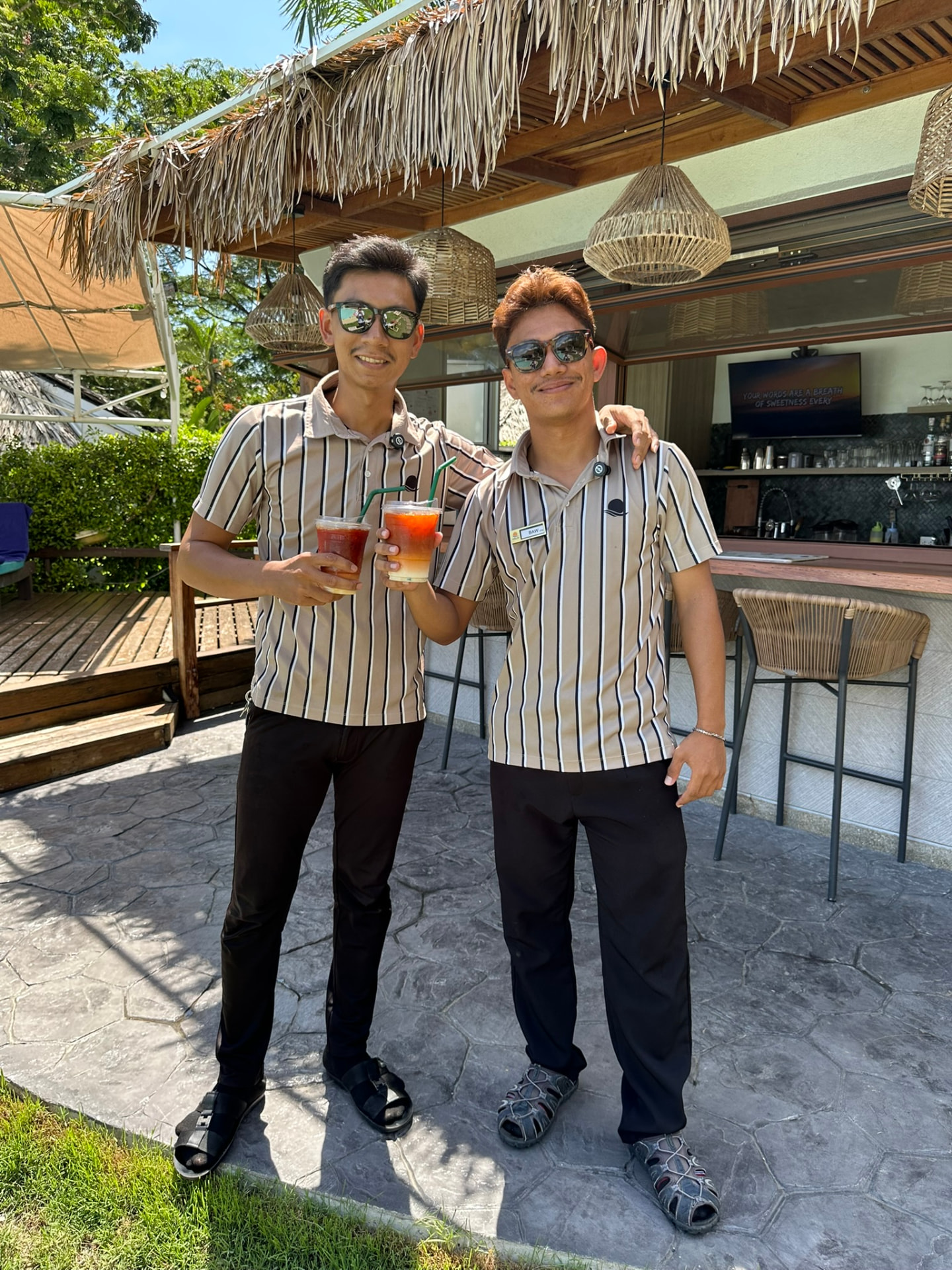 Two Northstar bartenders with drinks in hand outside the bar