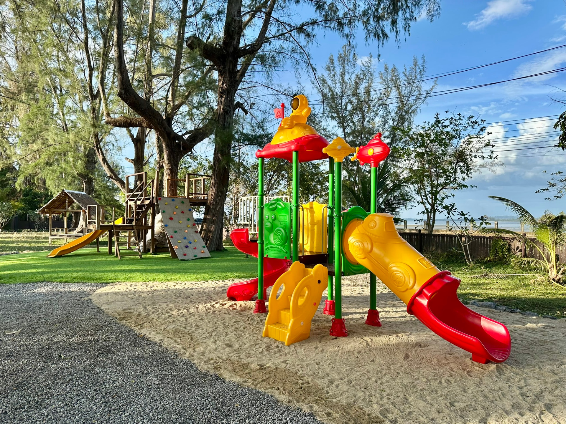 Colourful climbing frame with slides on the sand beside the sea