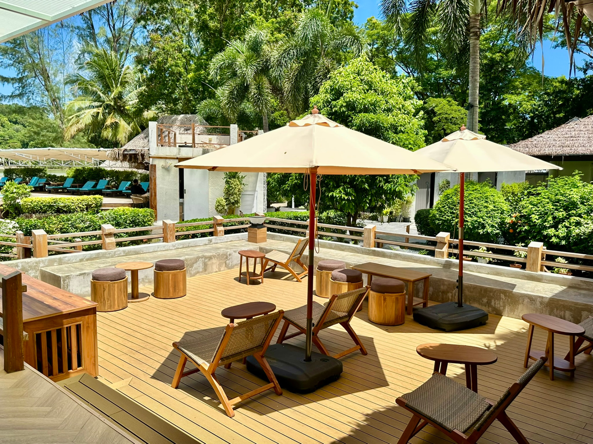 Shaded garden deck with parasols and low teak seating