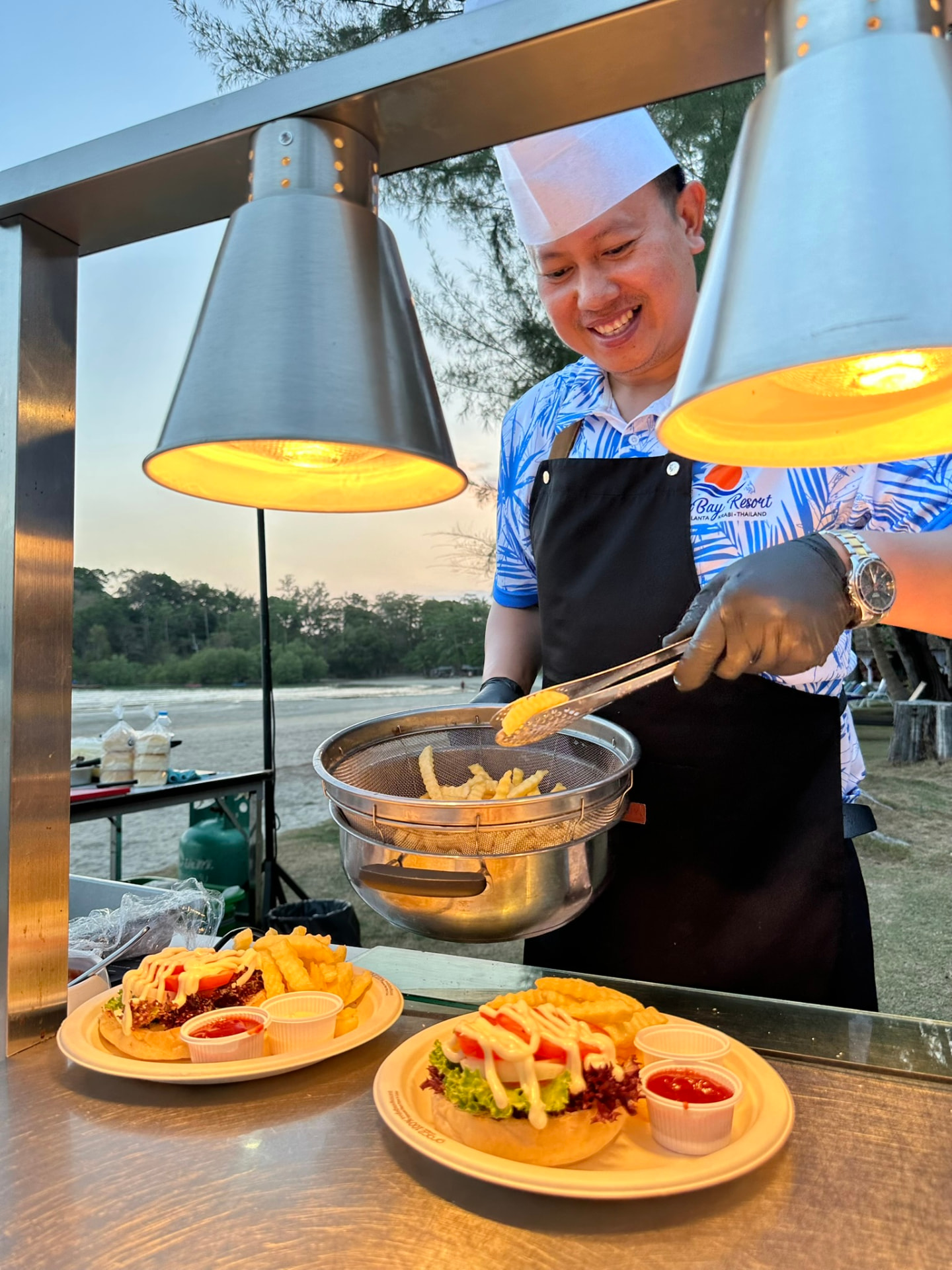 A TwinBay chef cooking for guests at the beach barbecue