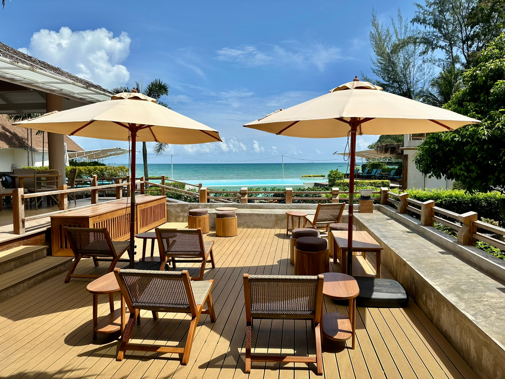 Sun deck with parasols looking over the pool to the sea