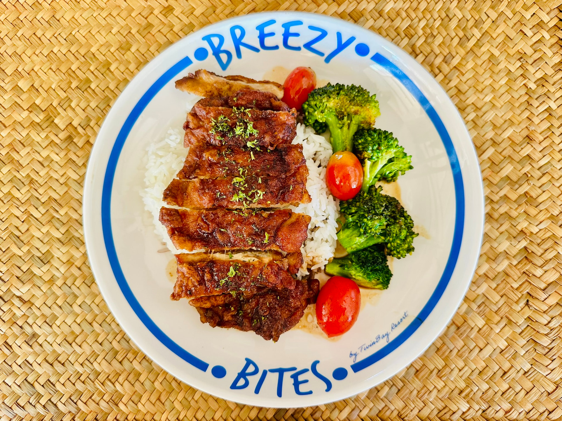 Crispy chicken with rice, broccoli and tomatoes on a Breezy Bites plate