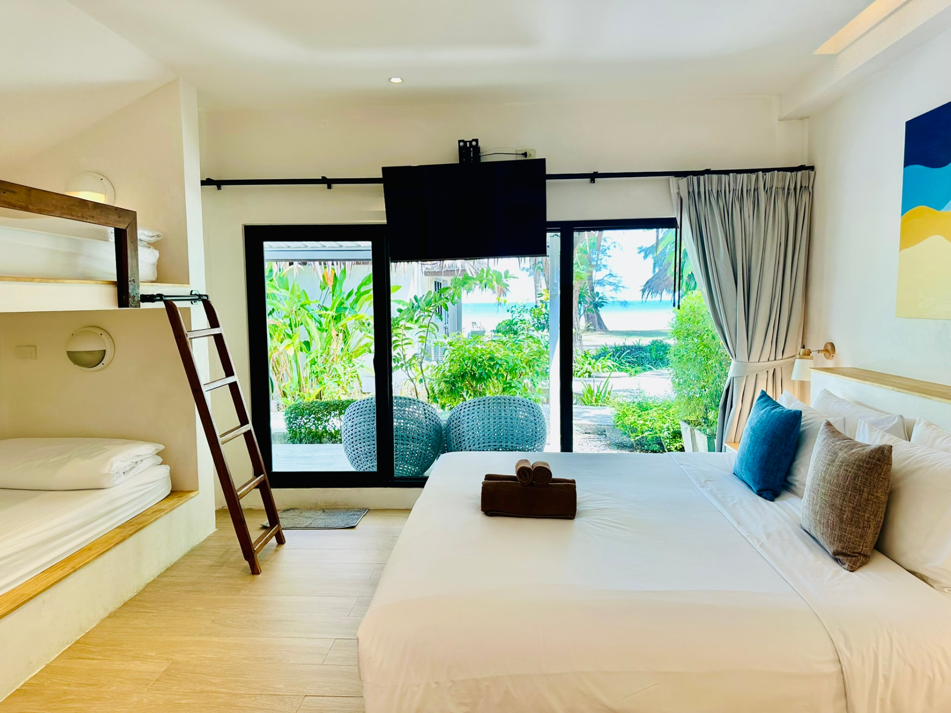 Bungalow interior looking through sliding doors to the garden and the sea beyond