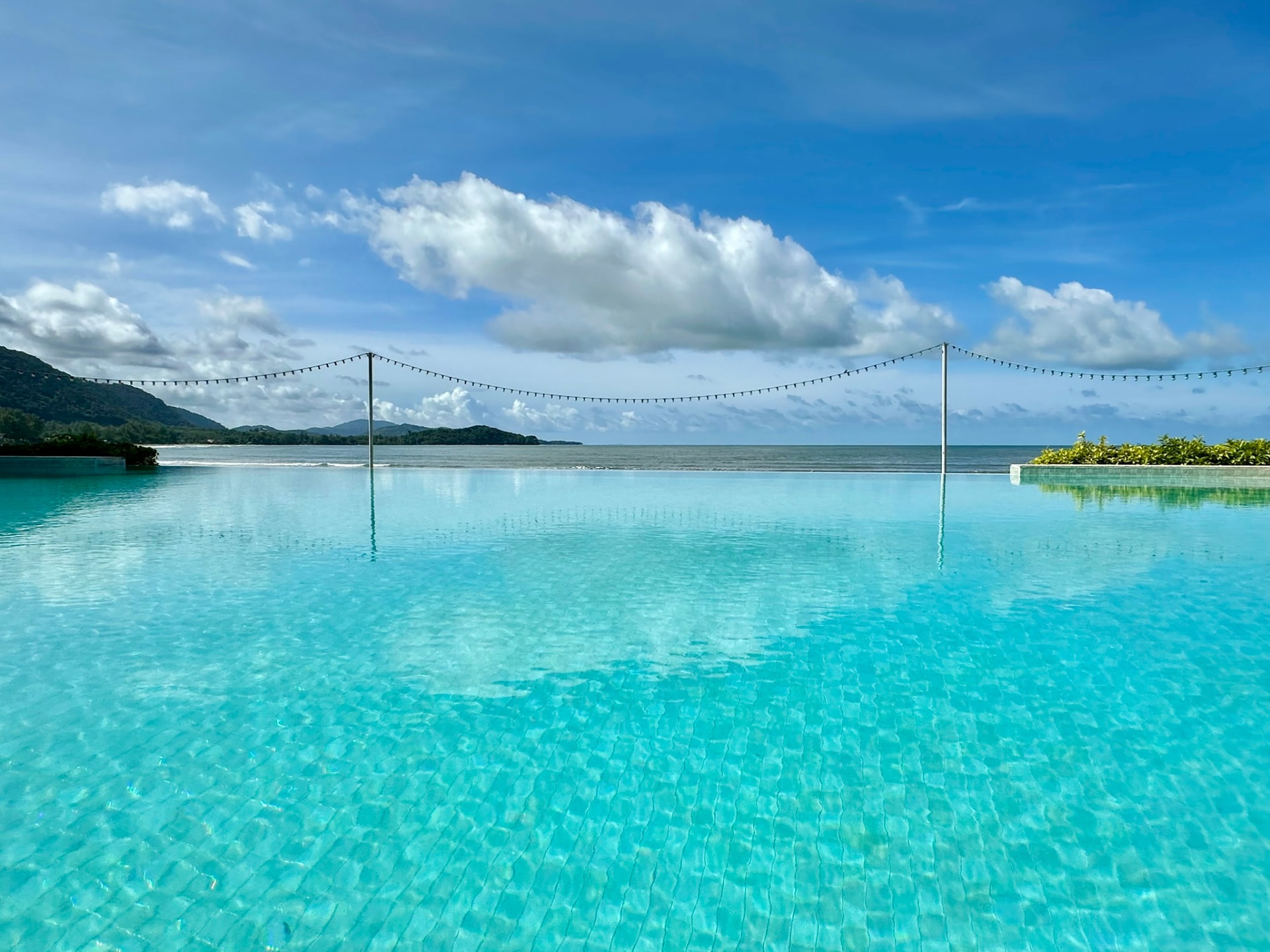 Clouds over the bay seen across the infinity pool