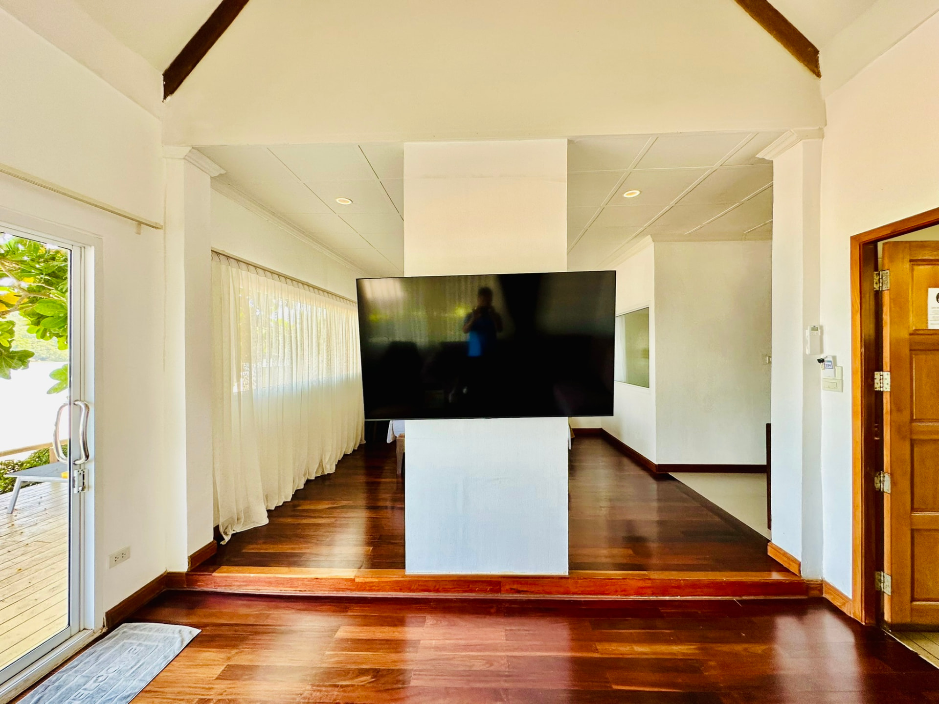 Polished timber floor running from the entrance past a wall-mounted television