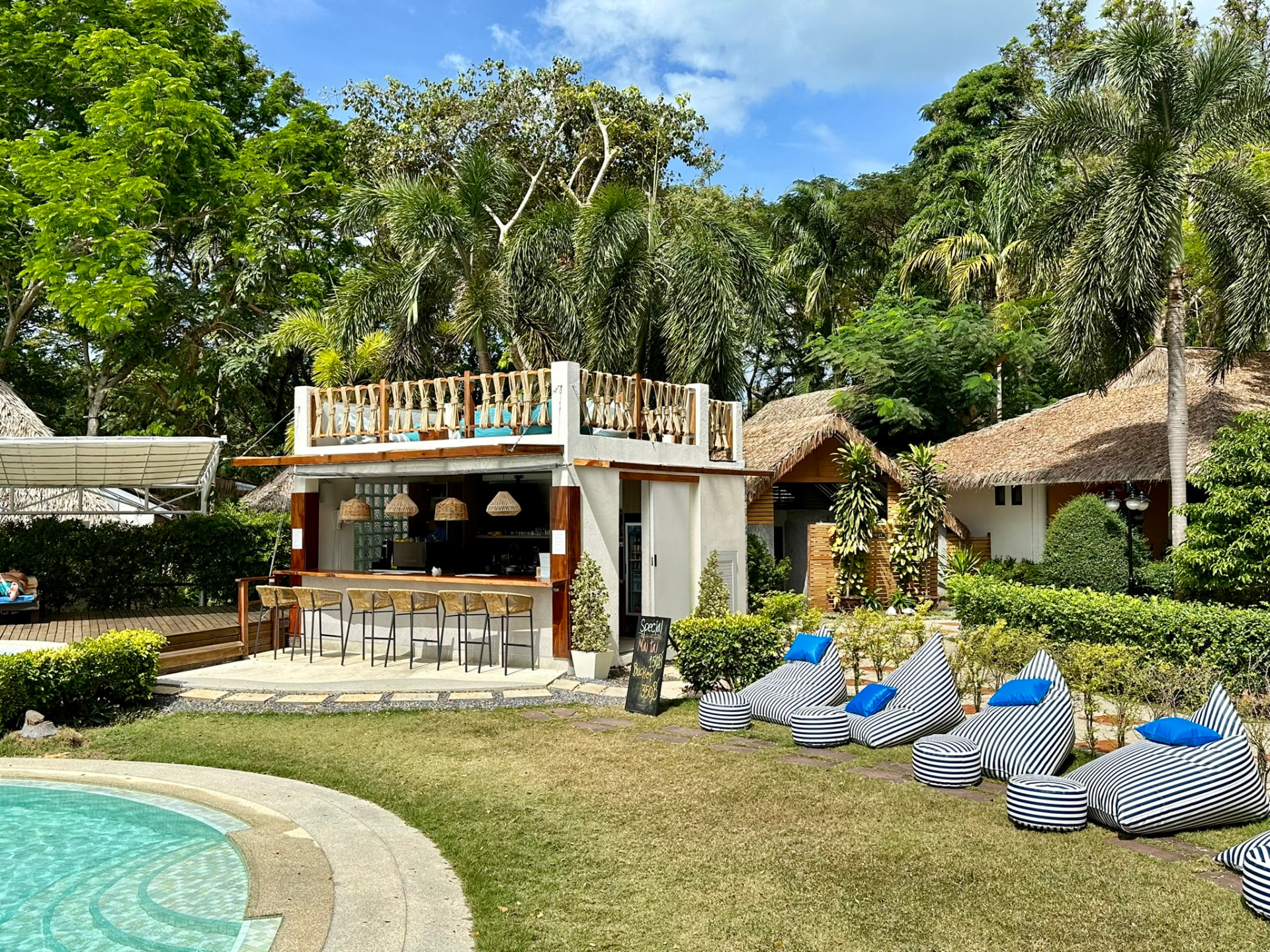 Northstar Bar seen across the lawn and pool with striped bean bags