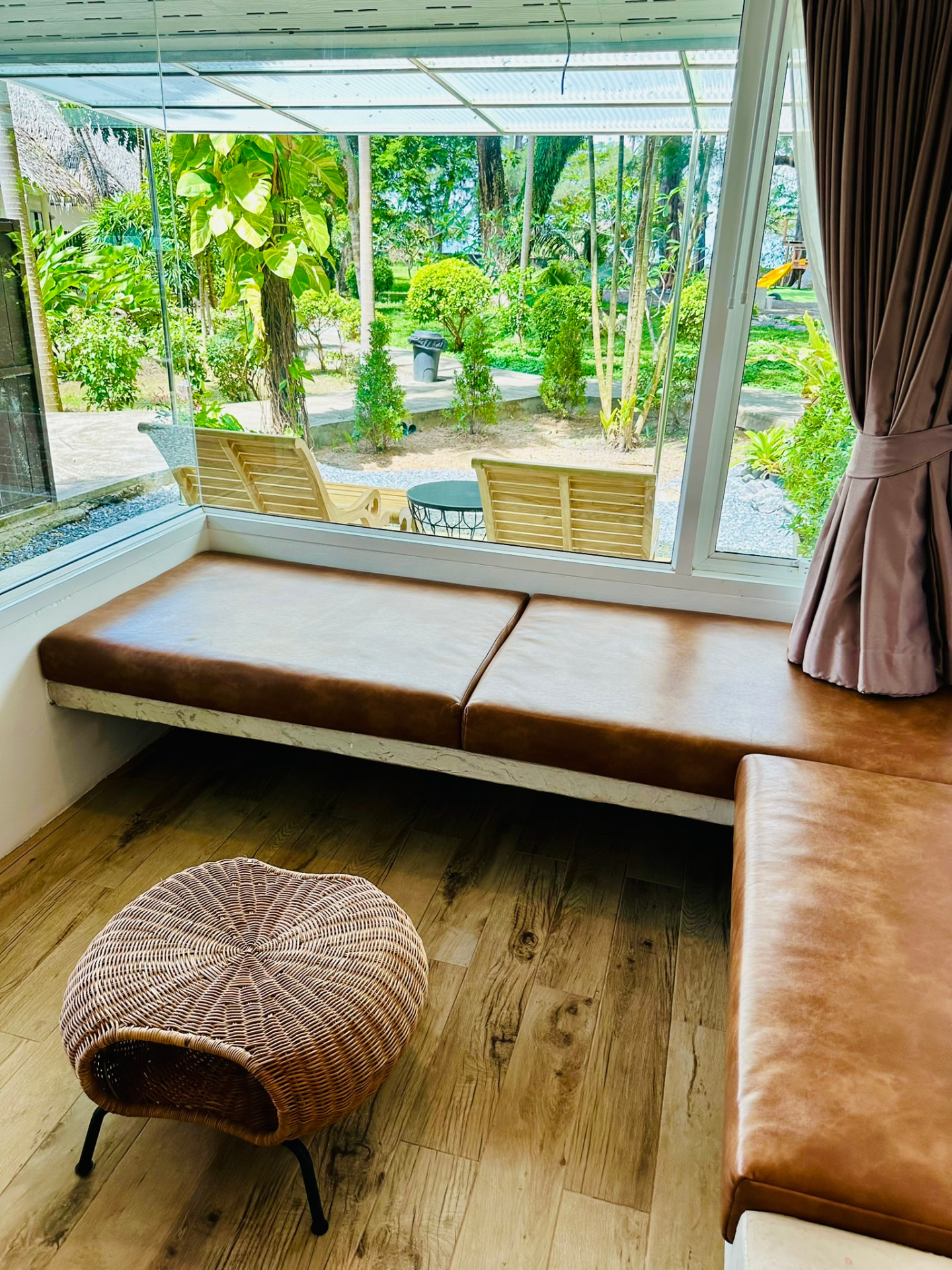 Leather window seat looking out over the garden and terrace loungers