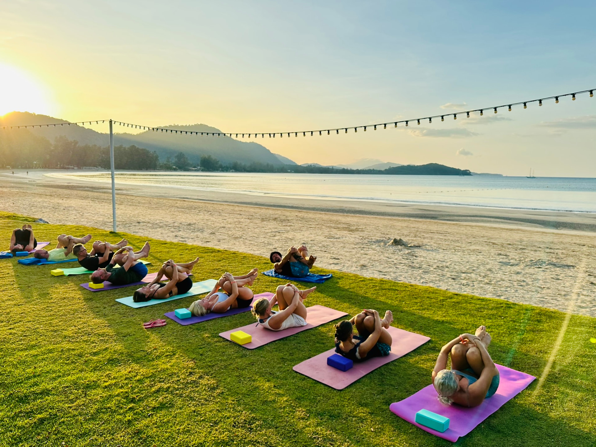 A sunrise yoga class on the lawn above the beach at TwinBay Resort