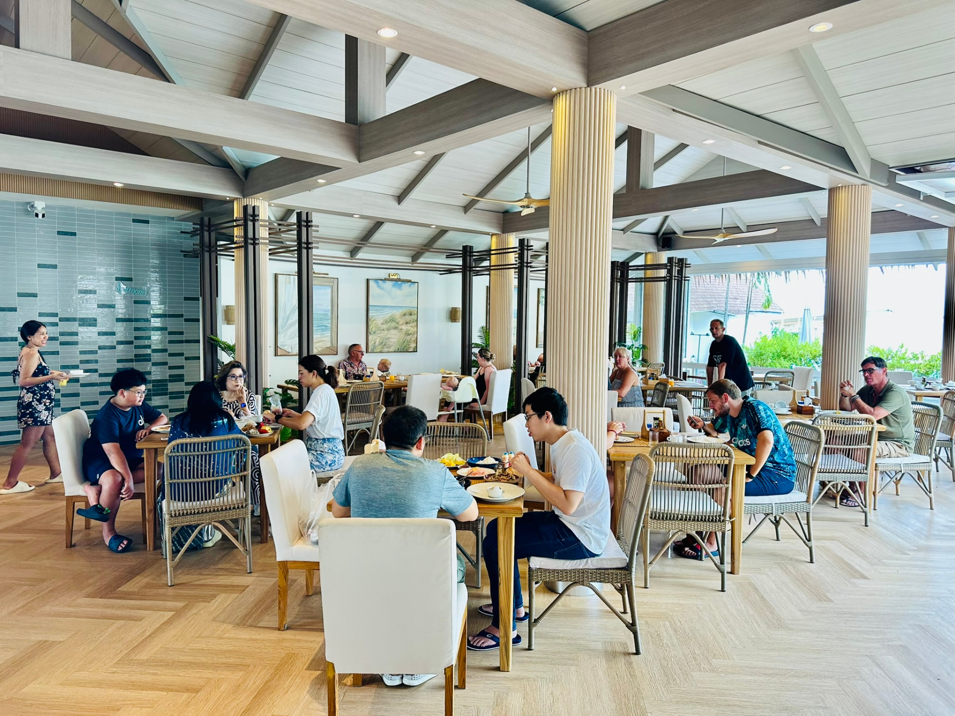 Guests having breakfast together in the Breezy Bites dining room