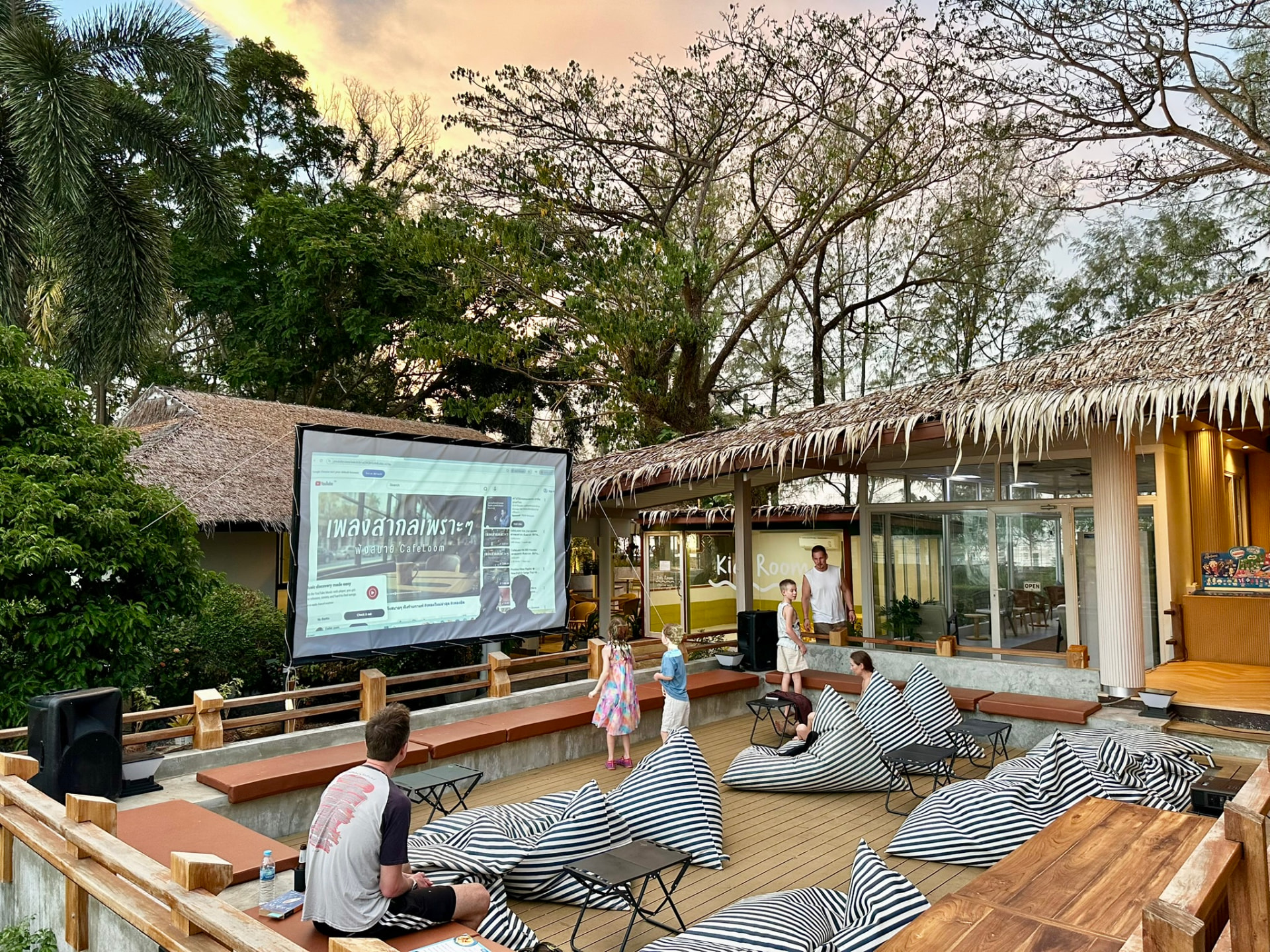 Children wandering between bean bags as the screen is set up at Breezy Bites