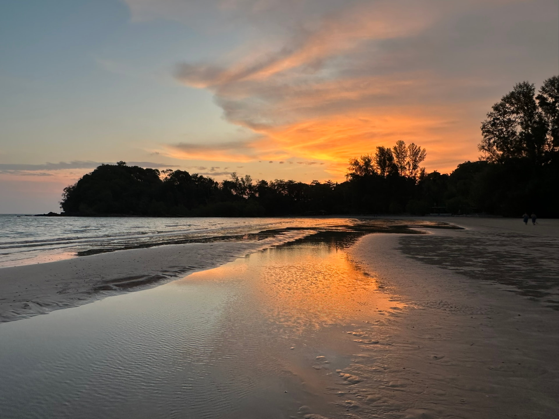 Sunset reflected in the wet sand along the beach at TwinBay Resort