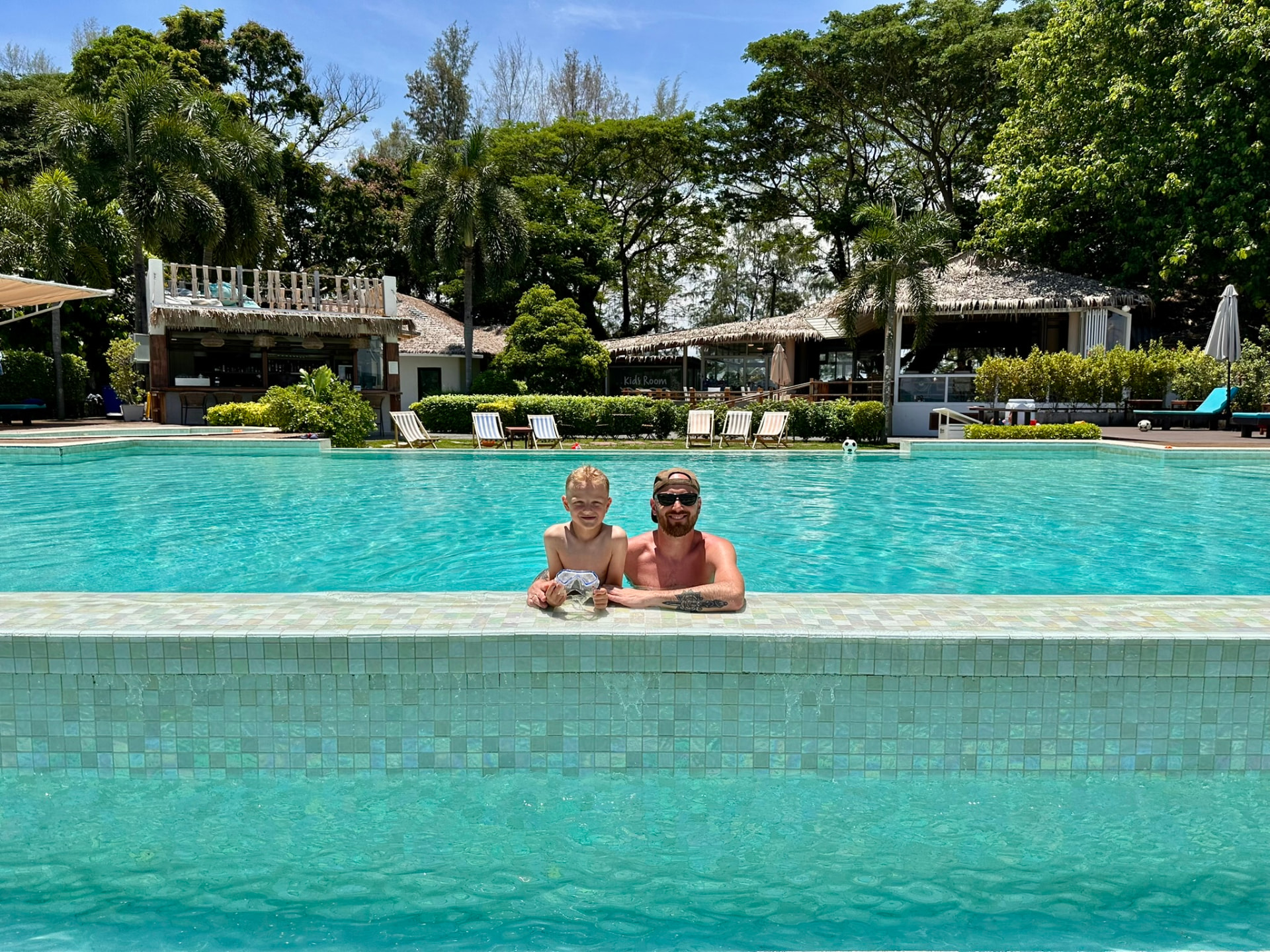 A father and son in the pool at TwinBay Resort