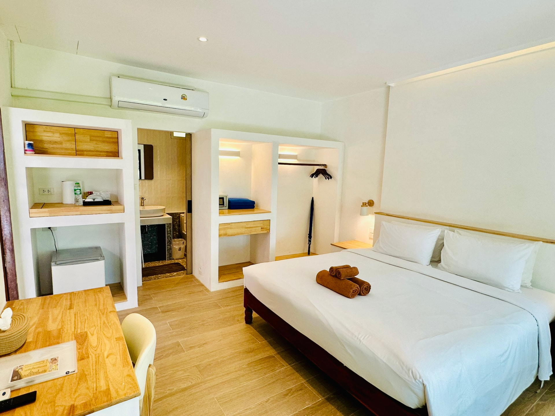 Open wardrobe, dressing nook and mini bar alongside the king bed